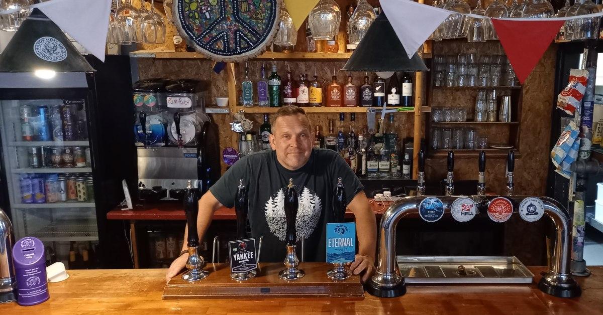 Photo of Lee Bellwood, owner of Major Tom's Social in Harrogate, behind the bar.