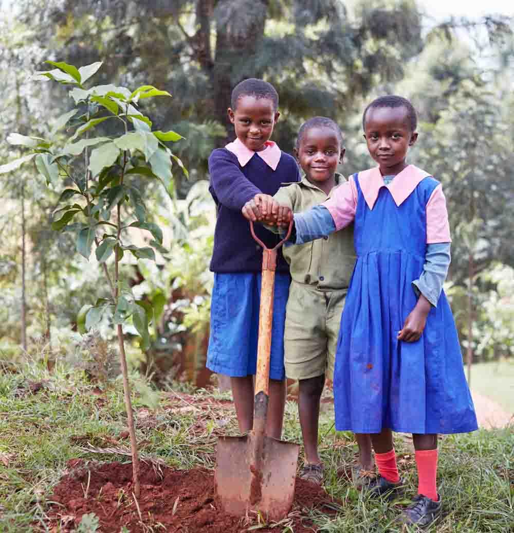 Three children, Kenya, planting trees