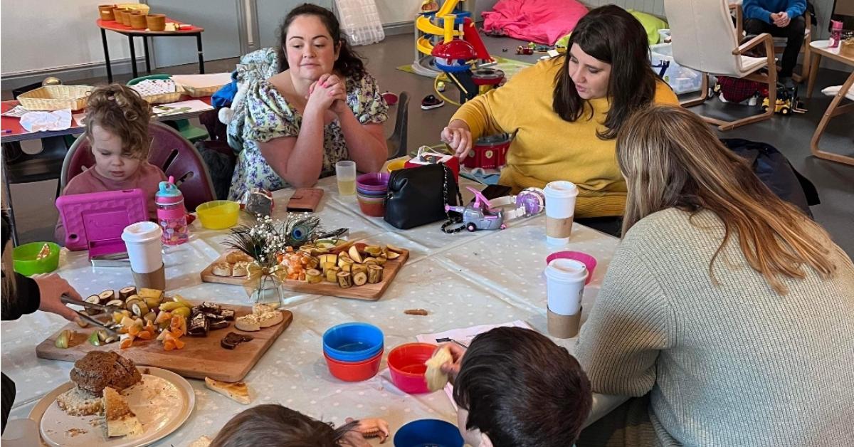 Parents and children enjoying food and drink at the first Neuropdiverse Stay &amp; Play session in Oatlands Community Centre in Harrogate.