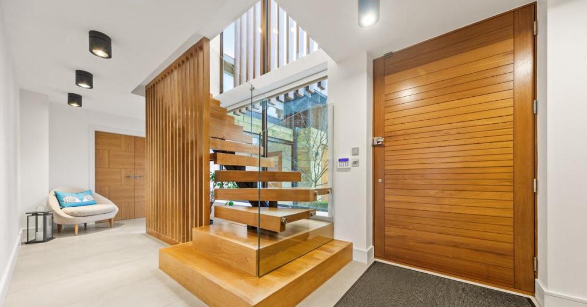 The hand-made oak staircase with glass balustrade.