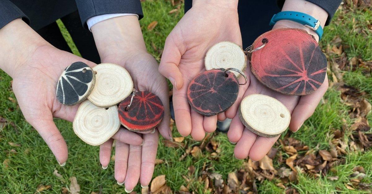 The hand-made keyrings are decorated with their student-run company 'orange slice' logo.