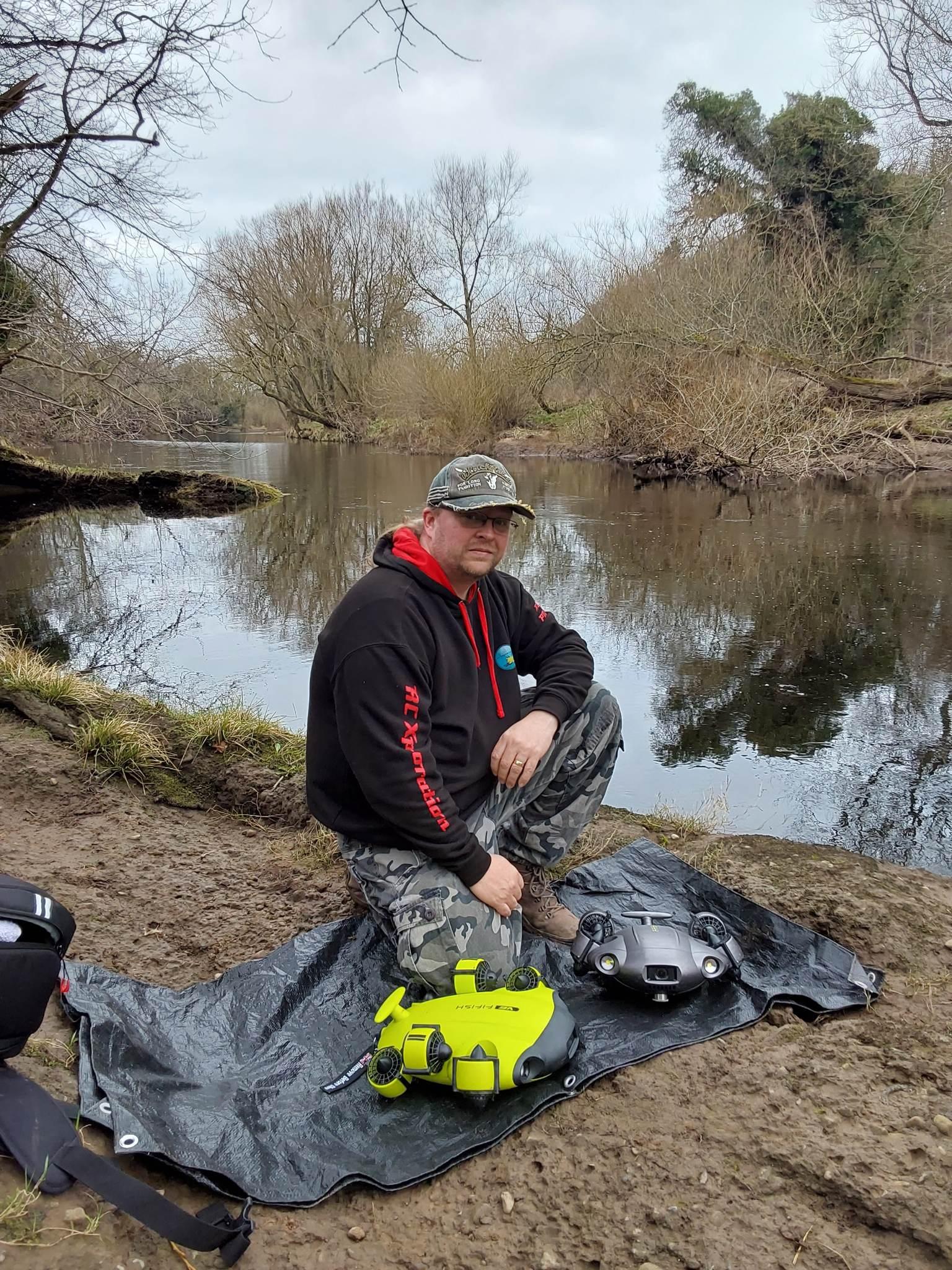 Picture of underwater drone enthusiast Adam Makewell on a riverbank in Ripon.