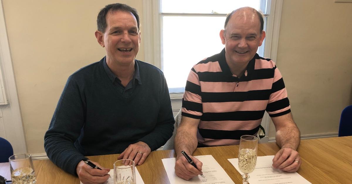 Peter Lacey, owner of The Whole System Partnership, and James Wright sign the trust papers.