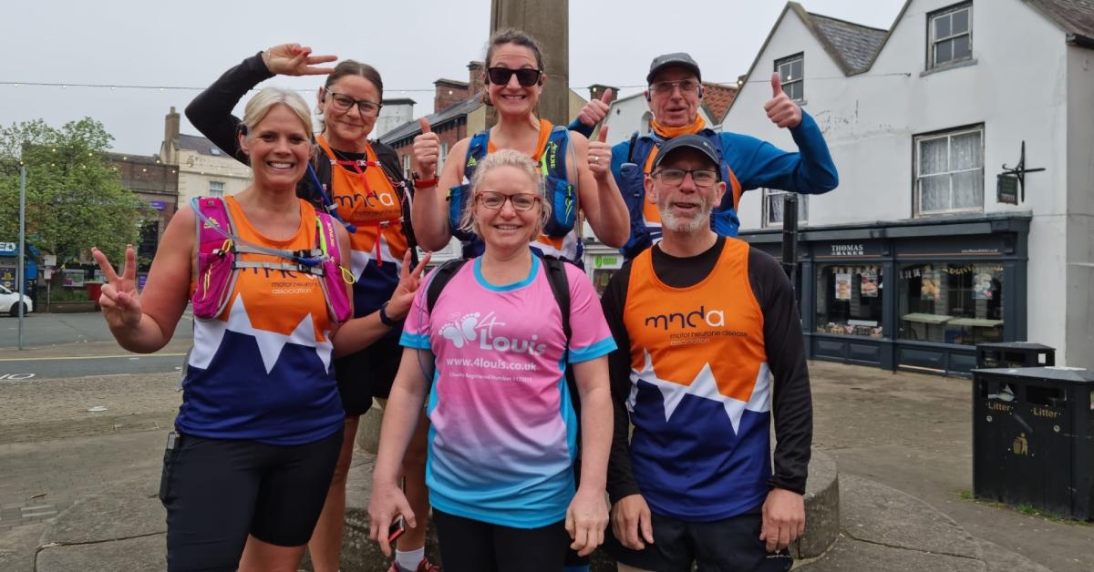 Photo of Dr Deborah Goldfield with five fellow Early Bird Running Crew runners at their Market Place meet-up in Knaresborough.