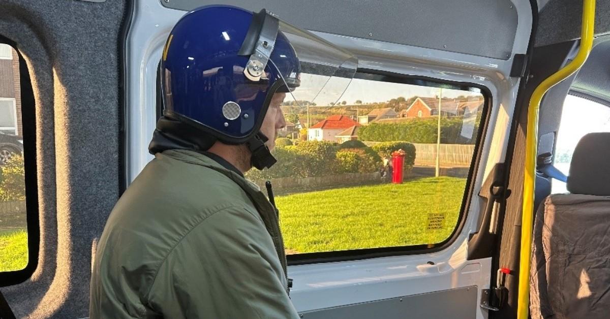 Photo of a plain-clothes police officer wearing a crash helmet in preparation for a County Lines drugs raid.