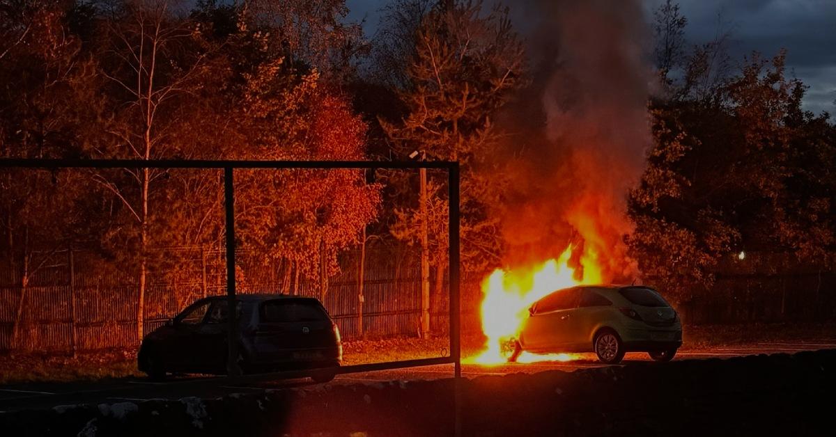 Photo of a car on fire in the car-park of RHS Harlow Carr.