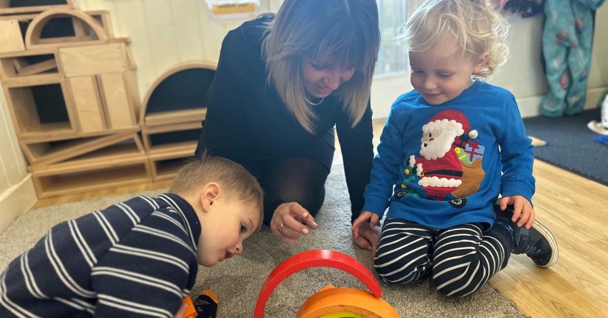 A photo of Nicola Stanworth of Children's Corner playing with her children.