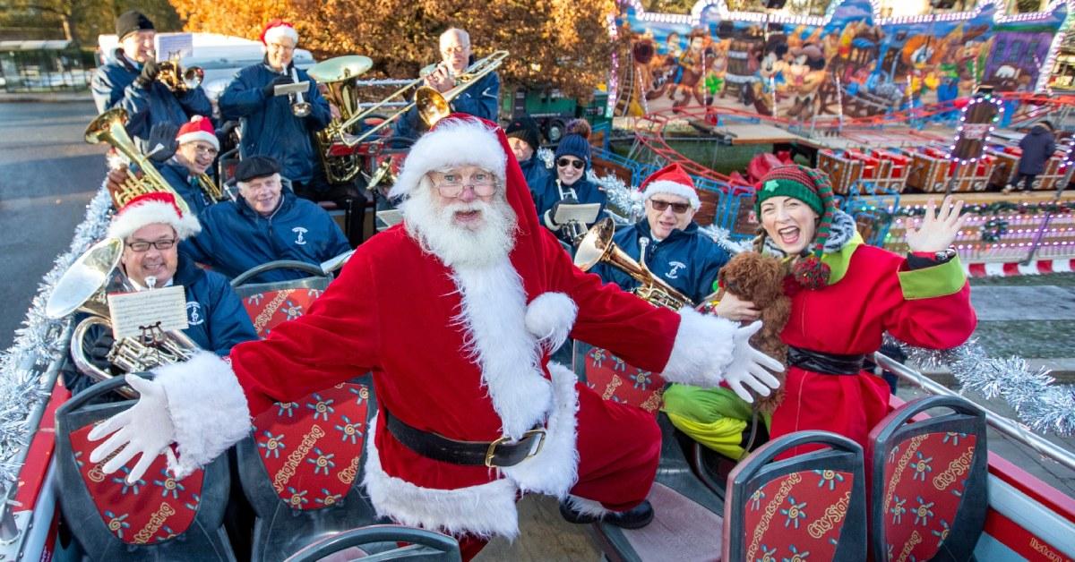 father-christmas-and-his-elves-have-a-blast-with-the-summerbridge-and-dacre-silver-band-atop-the-new-open-top-bus-experience-as-part-of-the-harrogate-christmas-fayre