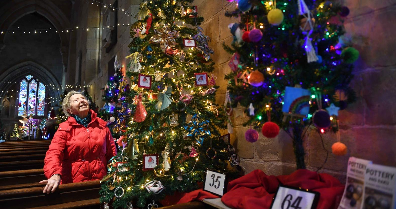 christmas-tree-festival-st-johns-church-knaresborough-pictured-sheila-betts-admires-one-of-the-trees-on-display-in-the-church-picture-gerard-binks