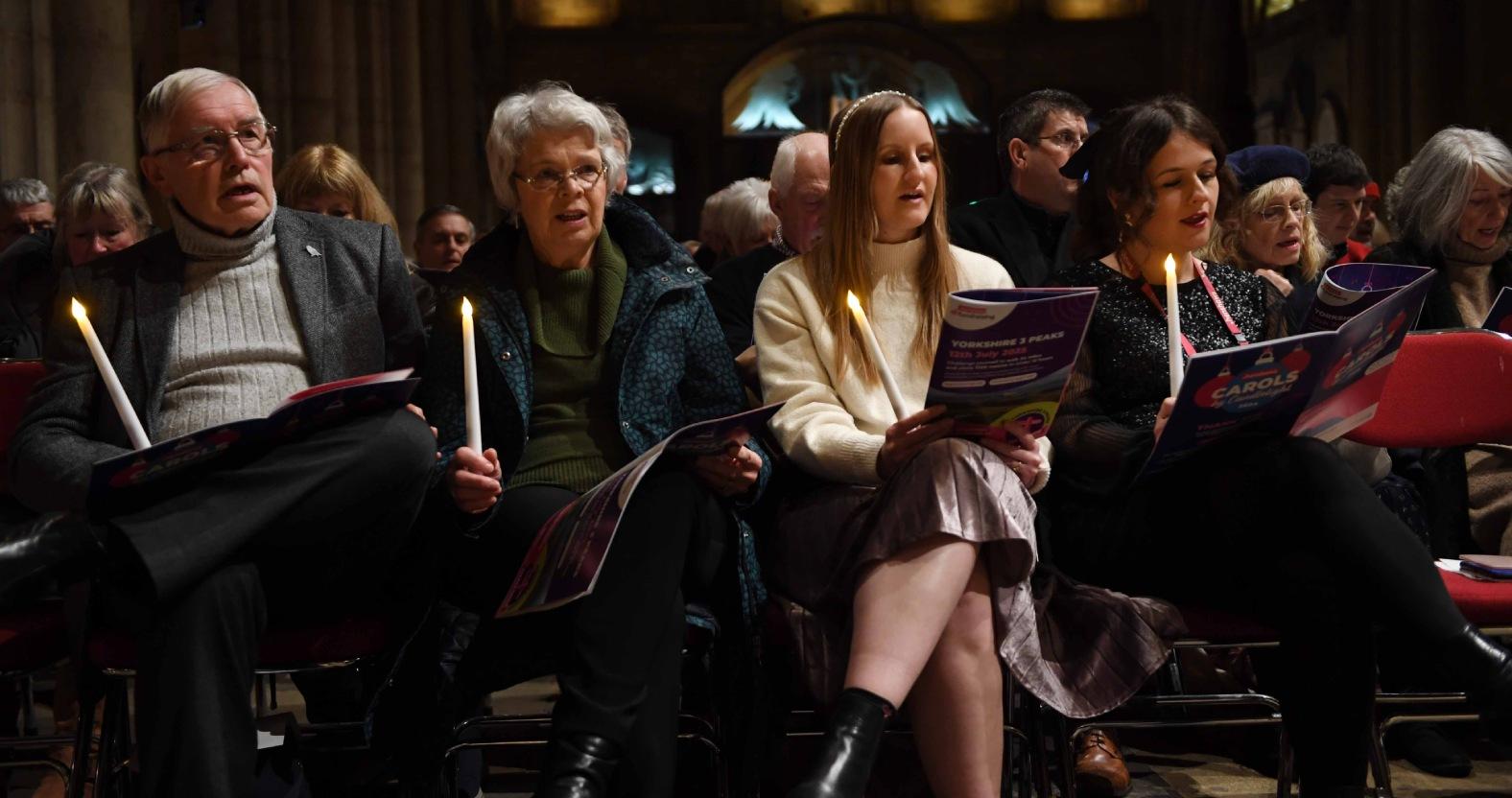 henshaws-carols-by-candlelight-concert-at-ripon-cathedral-pictured-guests-sing-under-candle-light-picture-gerard-binks
