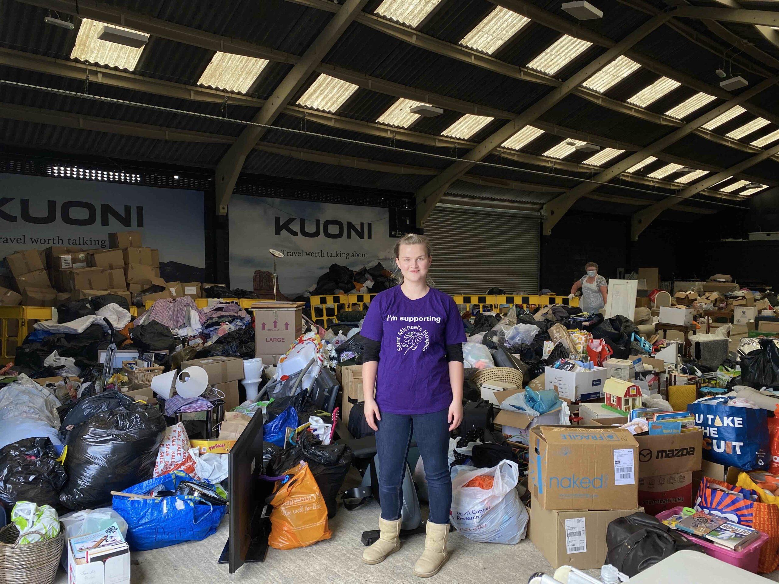 volunteer-surrounded-by-donations