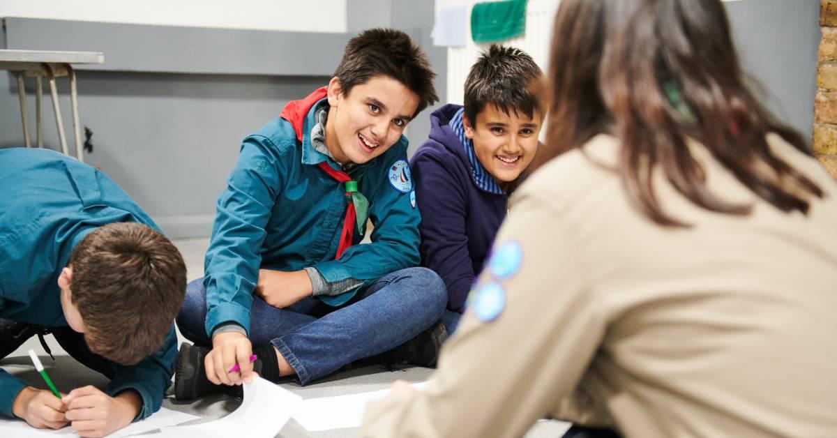 a-young-leader-supporting-three-scouts-to-come-up-with-programme-ideas