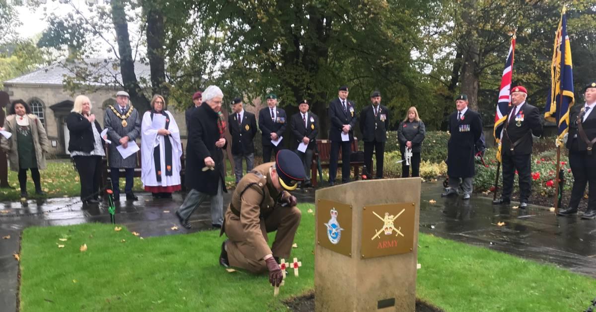 Royal Engineers officer places Poppy cross by plinth