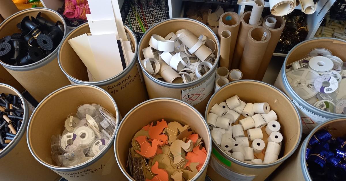 Photo showing barrels of sorted waste items donated the the Cone Exchange's scrap shop for use by crafters.