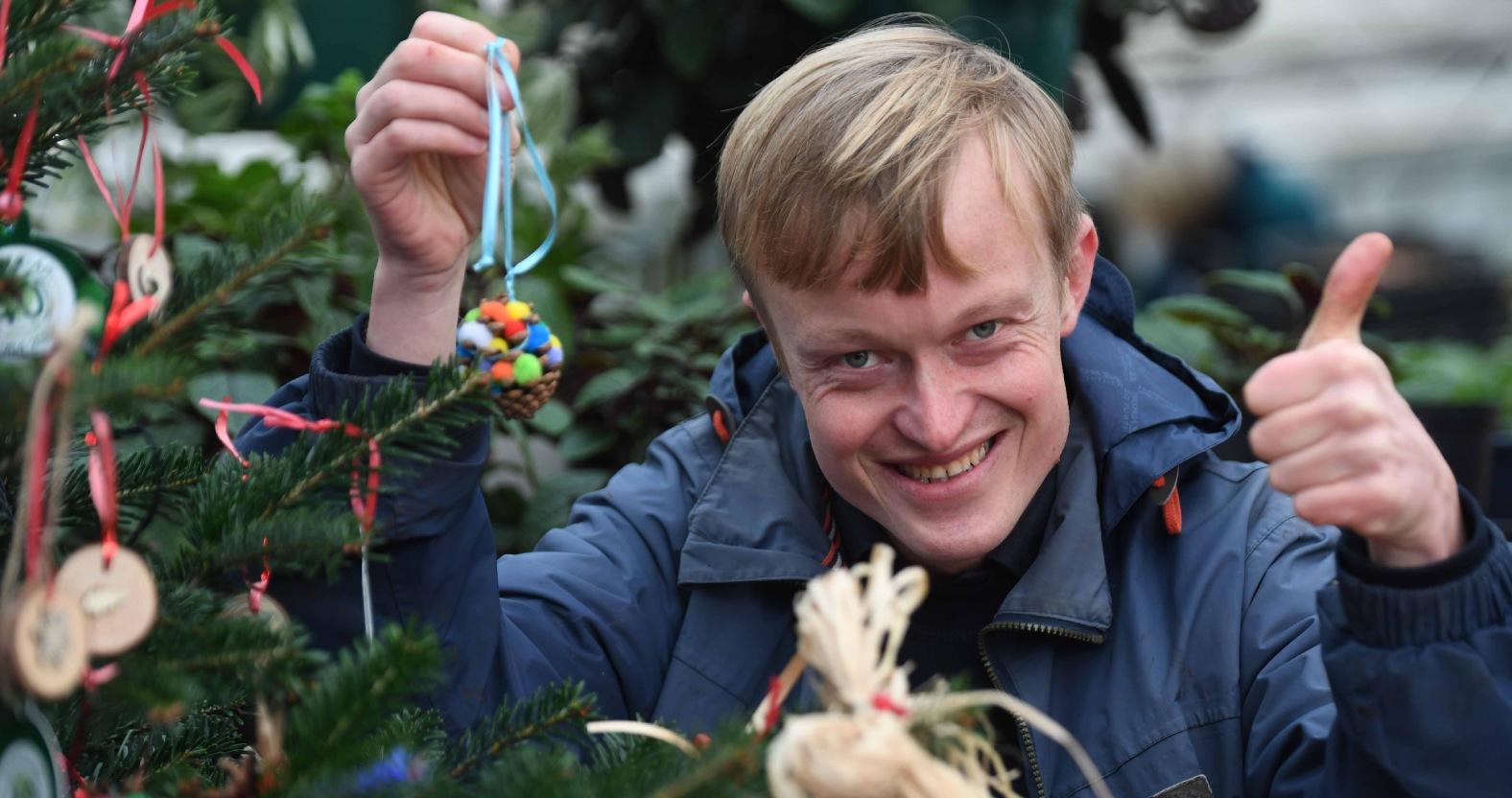 horticap-student-scott-tesseyman-hanging-handmade-decorations-on-the-horticap-christmas-tree