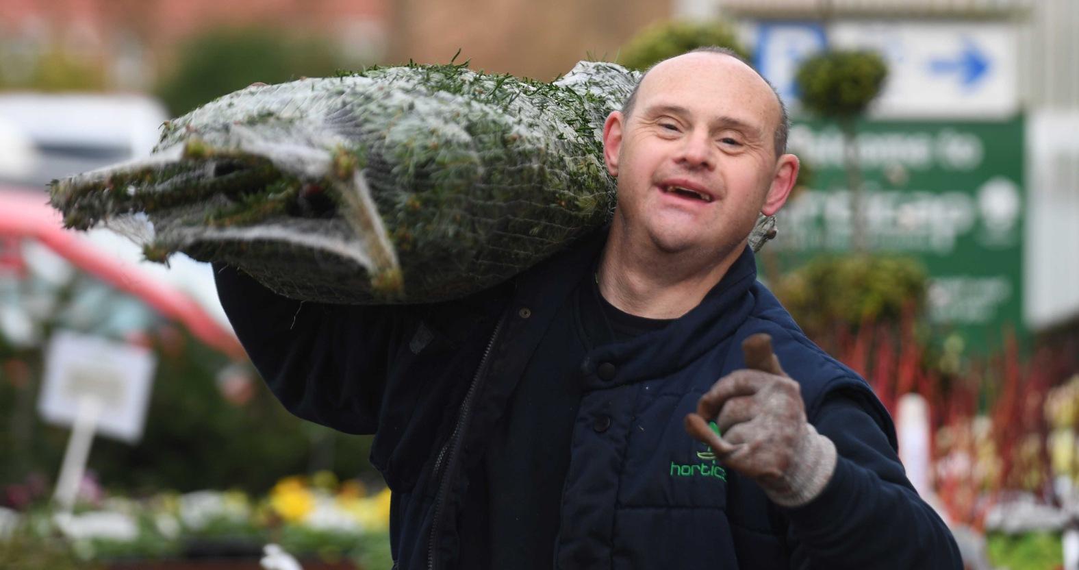 pictured-horticap-student-andrew-atkinson-helping-to-carry-christmas-trees-for-customers
