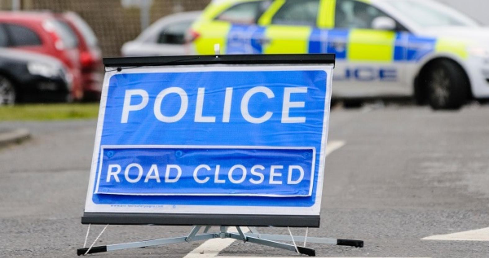 police-road-closed-sign-with-police-car-blocking-the-road