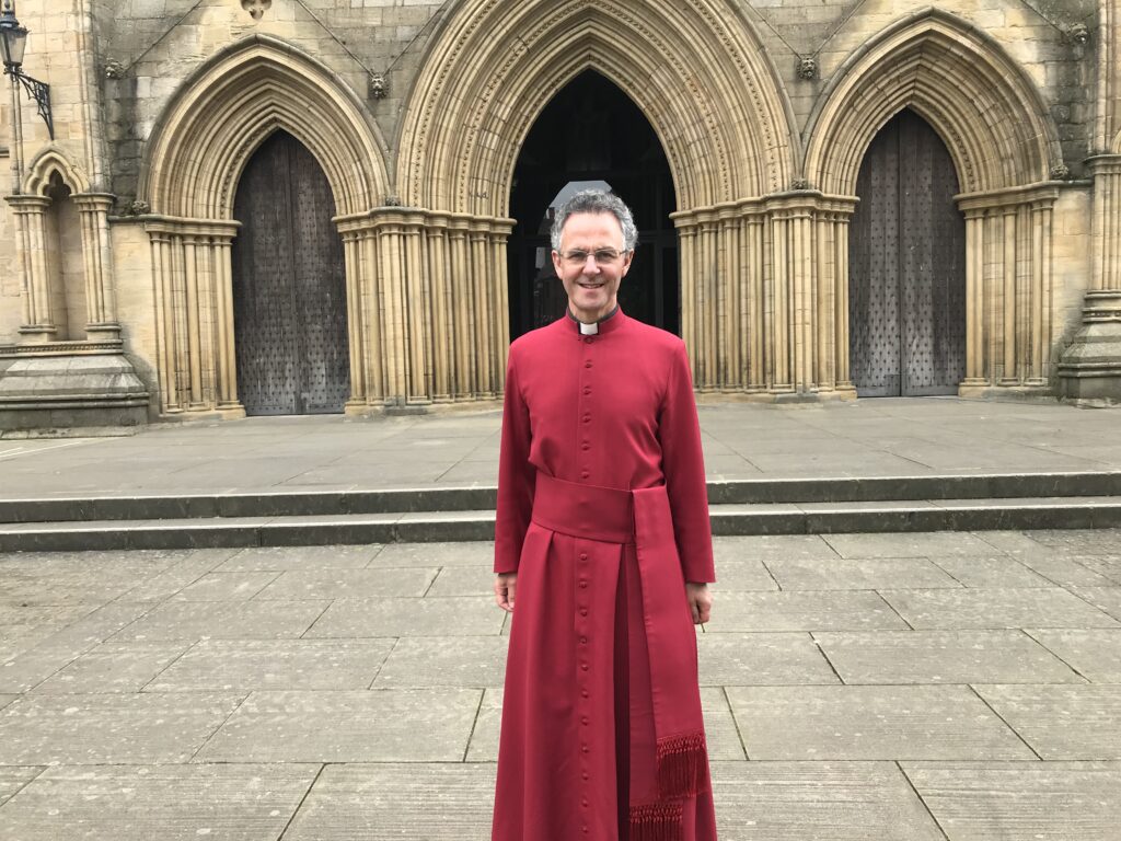 Photograph of Dean John Dobson outside Ripon Cathedral