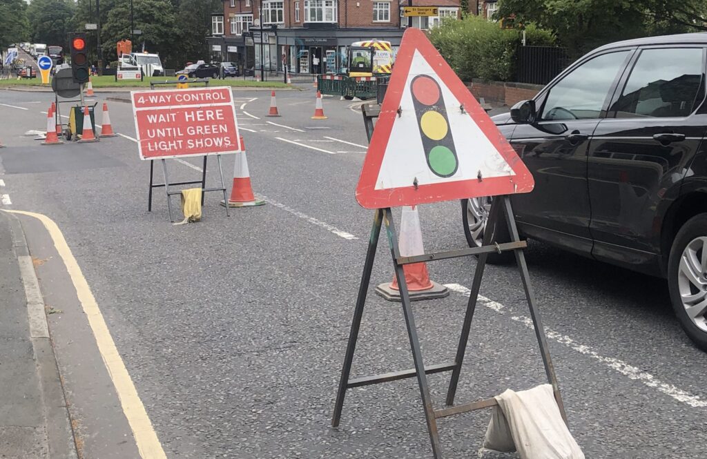 Temporary traffic lights on Leeds Road roundabout following roadworks.