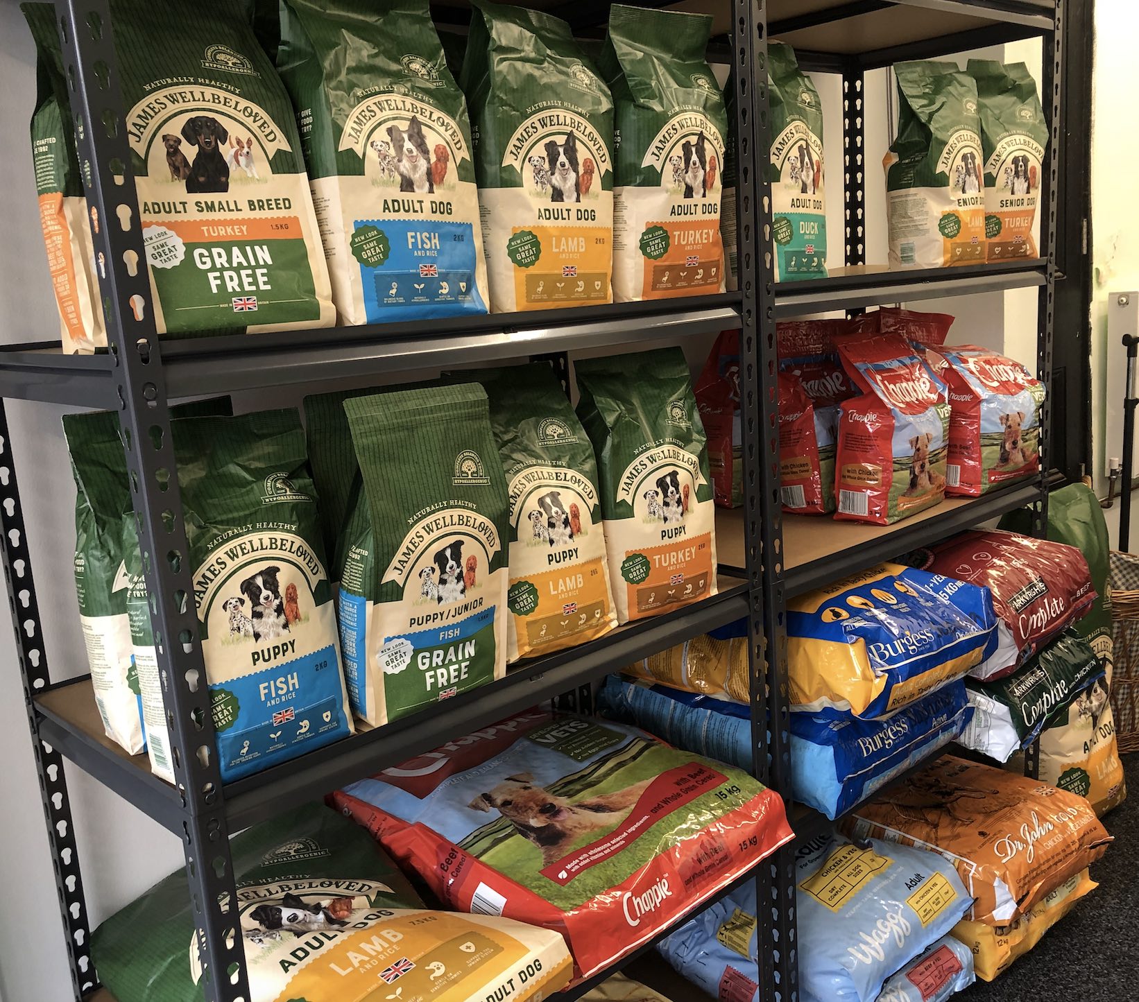 Shelves stacked with various brands of dog food.
