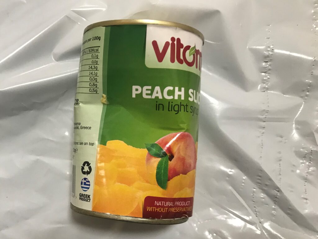 Photo of dented can of peach slices