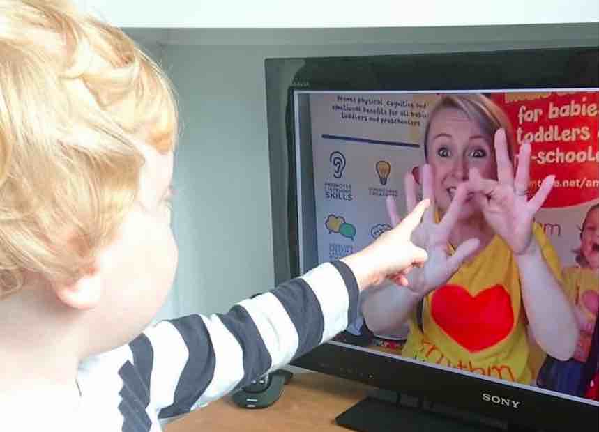 toddler point at animated tv screen