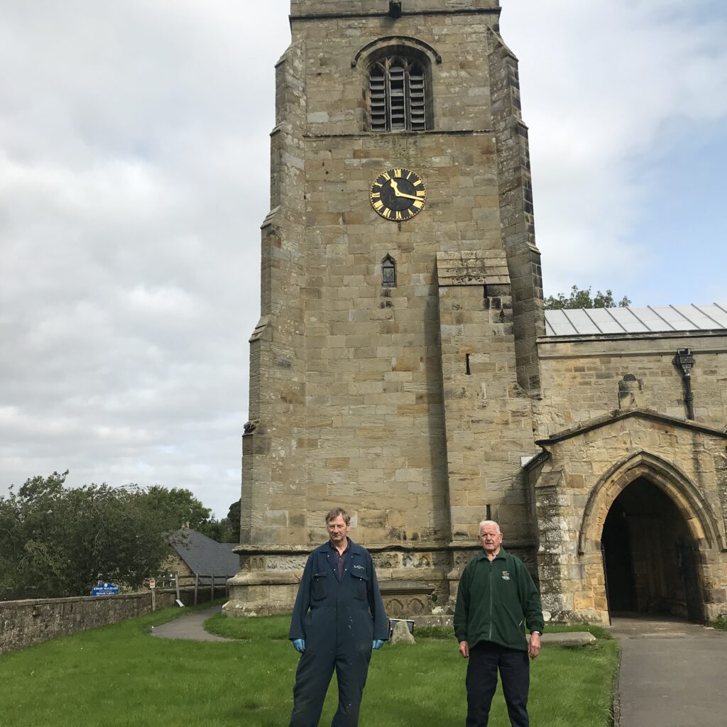 Photograph of Kevin Ireland and Christopher Slater with fixed clock