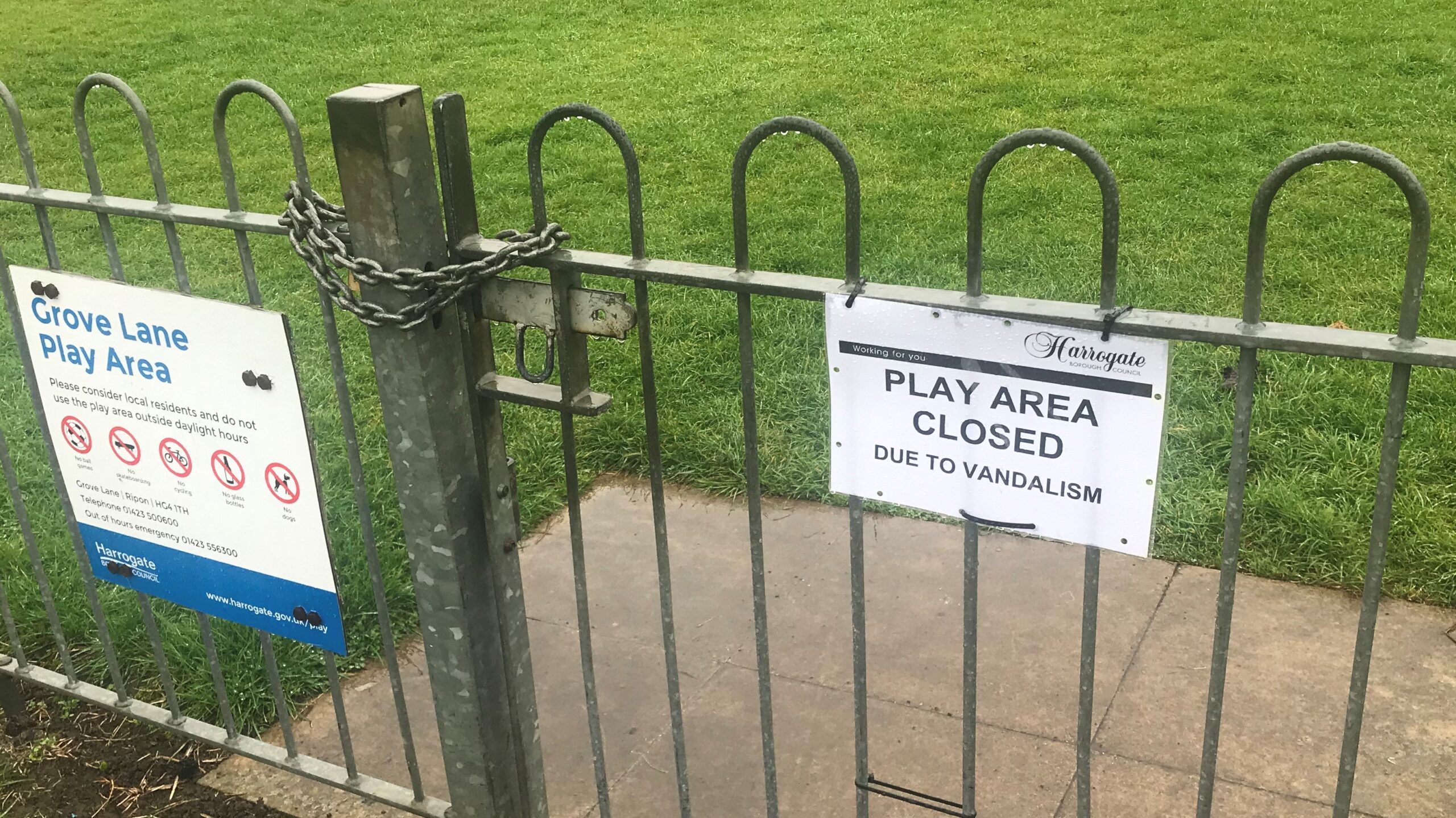 Photograph of the locked-up gate at the vandalised play area