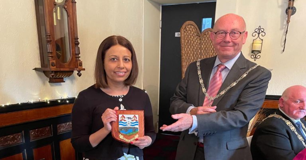 Pharmacist Samina Khan receives recognition from the Mayor of Pateley Bridge, Mike Holt.