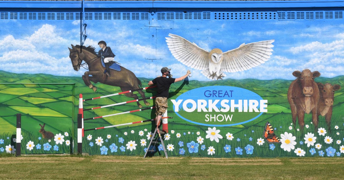 Artist Sam Porter at his newly completed mural at the Great Yorkshire Showground, ready for the Great Yorkshire Show.