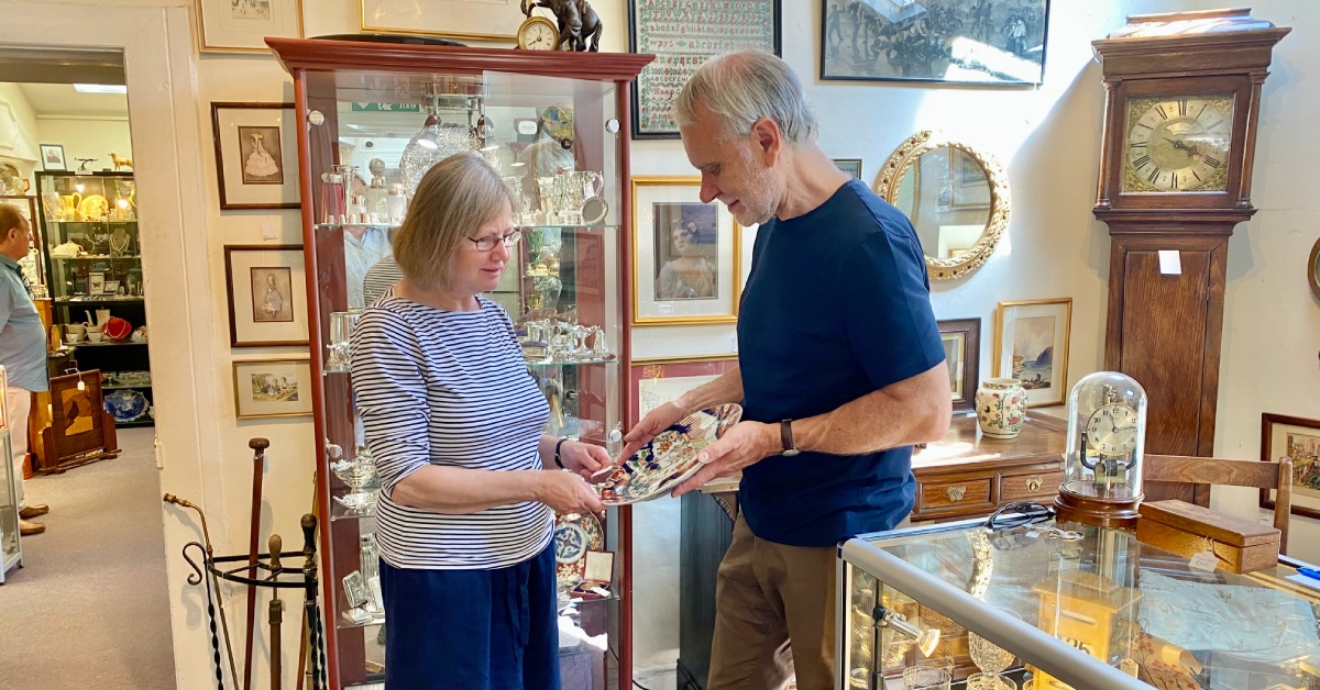 Photo showing a customer buying a piece of porcelain from an antiques dealer at Antiques on High in Harrogate.