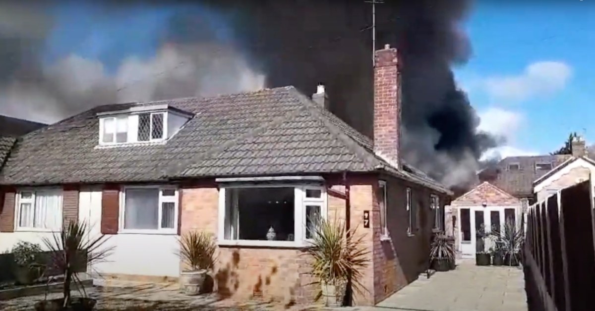 Photo of a house fire in Starbeck, with thick black smoke billowing from the rear of the building.